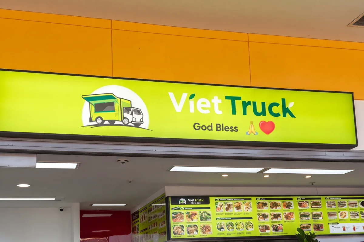The VietTruck shop at Fairfield West Plaza: the lime-green sign, the menu boards and the green tables